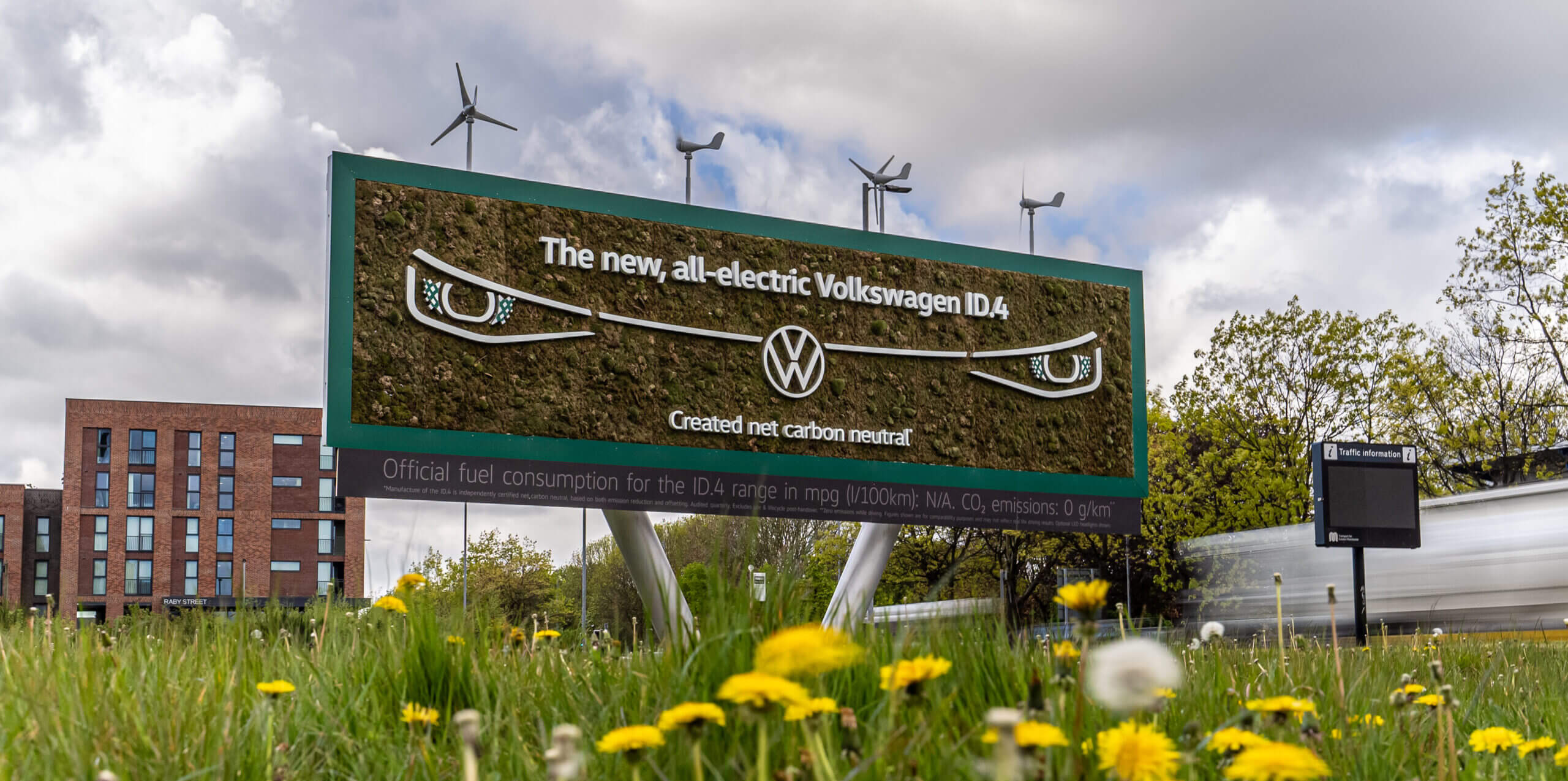The Volkswagen ID.4 Living Billboard in the daylight. The solar panels and wind turbines work hard to power the billboard later on in the evening.